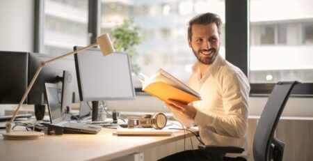 photo of man holding a book